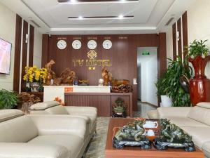 a lobby with couches and a tv hotel sign on the wall at Tv Hotel in Cao Bằng