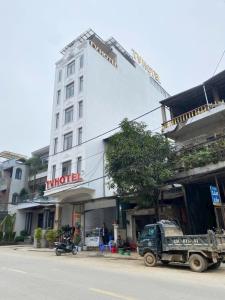 a military truck parked in front of a building at Tv Hotel in Cao Bằng