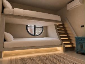 a room with two bunk beds and a window at Crown Chaloklum in Chaloklum +8 photos