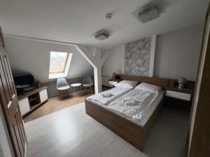 a bedroom with a bed and a desk and a television at Hotel Polonia in Ostrów Wielkopolski