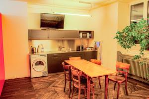 a kitchen with a table and a kitchen with a washing machine at Hotel Genossenschaft Kreuz in Solothurn +16 photos