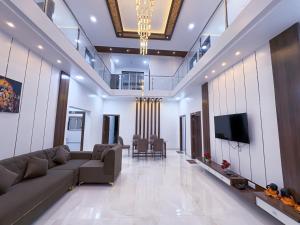 a living room with a couch and a tv at Advik Resort in Badlapur