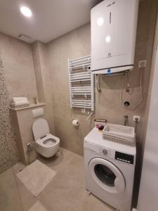 a bathroom with a washing machine and a toilet at Apartmani Antonela in Drasnice +49 photos