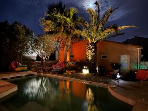 a swimming pool in a yard at night at Villa Flamingo GAYmen only b&b in Marseillan