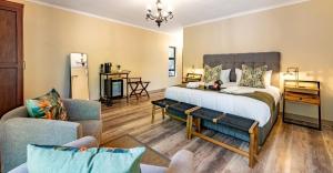 a bedroom with a bed and a living room at Mazuri Bush Cottages in Hluhluwe +115 photos