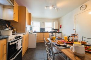 a kitchen with a table with food on it at Surfer 2Bed GF Flat Central Thurso, Parking, Fibre in Thurso