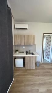 a kitchen with a sink and a counter top at Peania Domus in Paianía