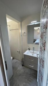 a bathroom with a sink and a mirror at Peania Domus in Paianía +59 photos