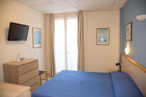 Postel nebo postele na pokoji v ubytování Hotel Delle Mimose
