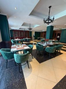 a dining room with tables and green chairs at Iconic Coworking Hotel in Addis Ababa +23 photos