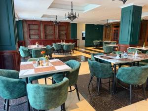 a restaurant with tables and chairs in a room at Iconic Coworking Hotel in Addis Ababa