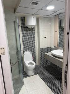 a bathroom with a toilet and a sink at Iconic Coworking Hotel in Addis Ababa