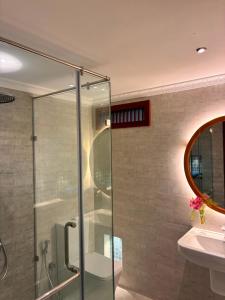 a bathroom with a glass shower and a sink at Lullaby Marine Villa in Wadduwa