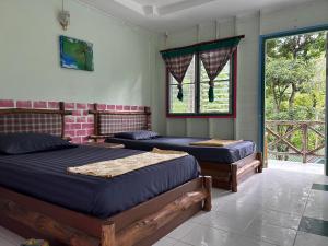 a bedroom with two beds and a window at Chill Out Bar and Bungalows in Tonsai Beach +79 photos
