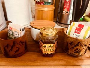 a wooden cutting board with a jar ofmed one spices at Durmitor Hideaway in Žabljak