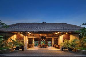 a house with a large roof with a patio at The Sterling Villas in Uluwatu
