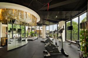 a gym with treadmills and ellipticals in a building at The Sterling Villas in Uluwatu +25 photos