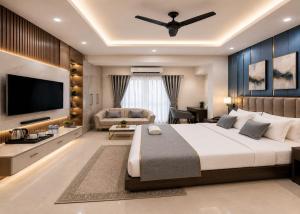 a bedroom with a large bed and a television at Hotel Grand Paul in New Delhi