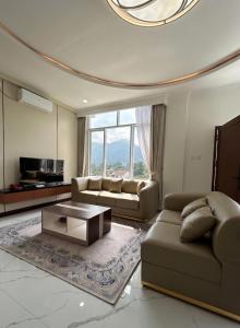 a living room with a couch and a coffee table at Milano Villas Puncak in Puncak