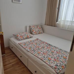 a bed with two pillows on it in a room at Bright & Spacious Apartment Budva in Budva