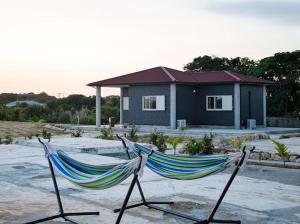 a couple of hammocks in front of a house at Sea Sky 赤崎 in Yoron