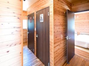 two elevators in a room with wooden walls at Sea Sky 赤崎 in Yoron +37 photos