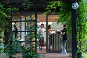 a group of people standing outside of a building at Rifugio diVino Dormire in una botte - Wine Barrel stay near Rome in Rieti