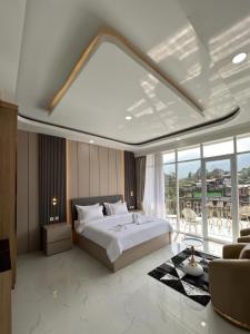 a bedroom with a large bed and a large window at Milano Villas Puncak in Puncak +90 photos