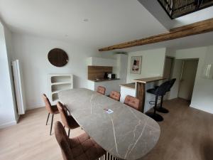 a dining room with a table and chairs at Les Appartements de Millau in Millau