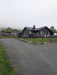 a group of houses on the side of a road at Harevadet 221 in Volda