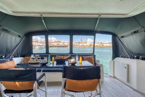 a dining room on a boat with a table and chairs at yacht Twenty Seven in Les Sables-d'Olonne