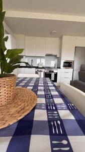 a kitchen with a table with a blue and white floor at AuraGalega Noro in Ribeira