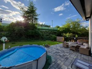a backyard with a hot tub and a patio at Ferienhaus "Pusteblume" - Entspannen in Weiterode in Bebra