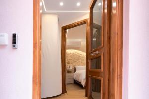 a door leading into a bedroom with a bed at LUM Luxury Studios in Rethymno