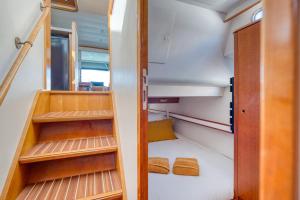 a small room with wooden shelves and a staircase at yacht Twenty Seven in Les Sables-d'Olonne