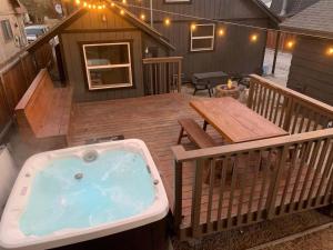 a deck with a jacuzzi tub on a house at THE OHANA at BIG BEAR in Big Bear City