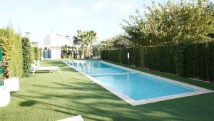 a swimming pool in a yard next to a fence at Amazing apartment direct pool acces in Denia