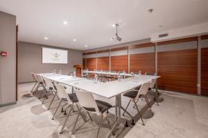a large conference room with a long table and chairs at White Hill Hotel in Tbilisi City