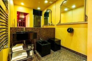 a yellow bathroom with a sink and a mirror at Rubra in Santerno +10 photos