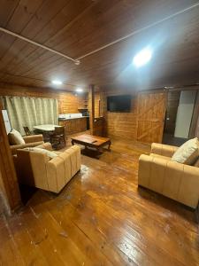 a living room with two couches and a table at carmel cabins suite 3 in Yājur