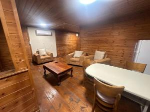 a living room with a couch and a table at carmel cabins suite 3 in Yājur