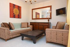 a living room with a couch and a table at Sunrise Horizon in Iraklitsa