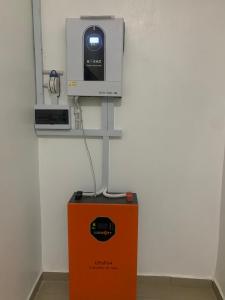 an orange box with a tv on top of it at Beacon Shortlet in Kaduna
