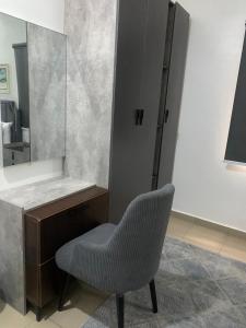 a bathroom with a chair and a mirror at Beacon Shortlet in Kaduna