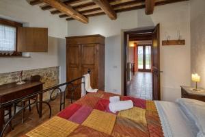 a bedroom with a bed and a table and a kitchen at Agriturismo Il Barco in Spello +119 photos