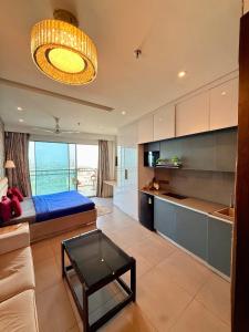 a living room with a bed and a table in a room at Nova Spira in Noida