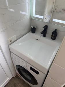 a white washing machine in a bathroom with a mirror at U-Home in Verkhovyna +17 photos