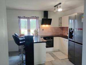 a kitchen with a black and white counter top at Leśny zakątek in Rękusy