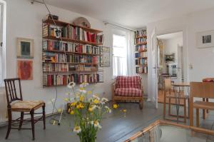 a living room with bookshelves and a table and chairs at trouve ferienwohnung in Doberlug-Kirchhain