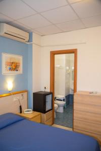 Postel nebo postele na pokoji v ubytování Hotel Delle Mimose